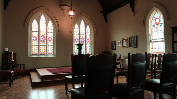"Interior of The Chapel at The Convent at Koroit, showcasing historic architecture, stained glass windows, and a serene, spiritual atmosphere."