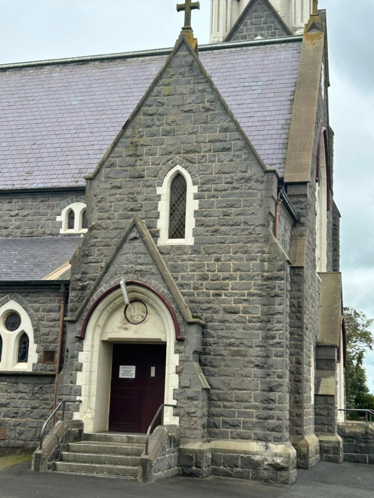 "Bluestone Catholic Church of the Infant Jesus in Koroit, featuring magnificent stained glass windows, located diagonally opposite The Convent."