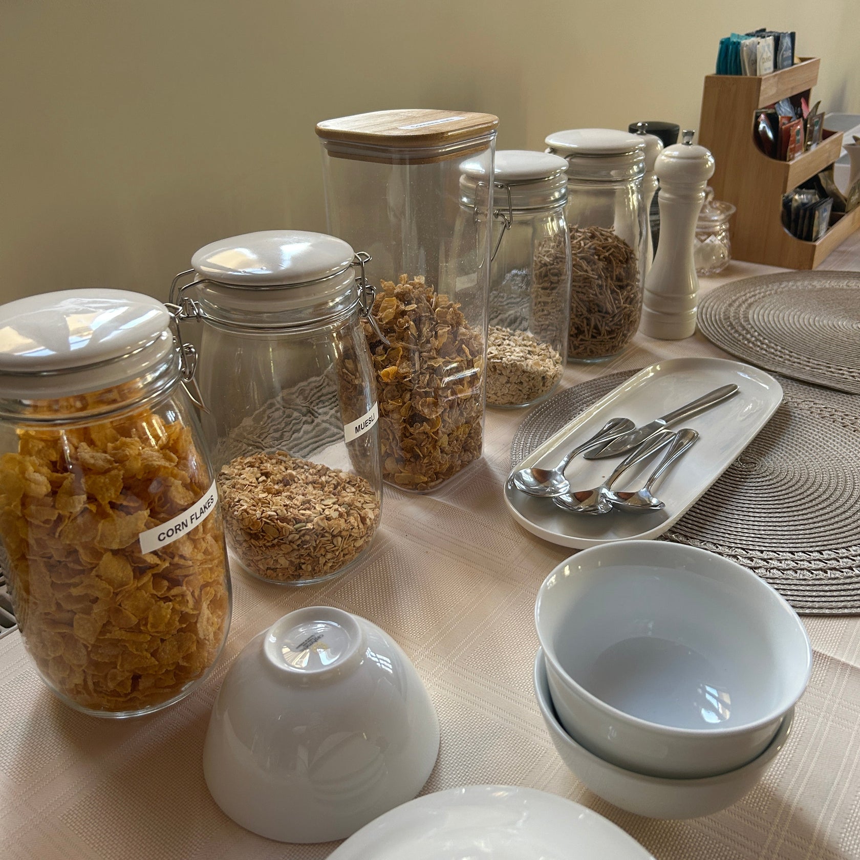 Set of glass jars with various cereals on a counter for guest breakfast at the Convent at Koroit.