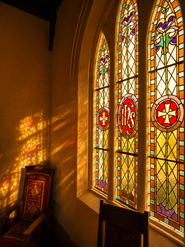 A stain glass window in the Chapel at the Convent at koroit with sunset light shining through.