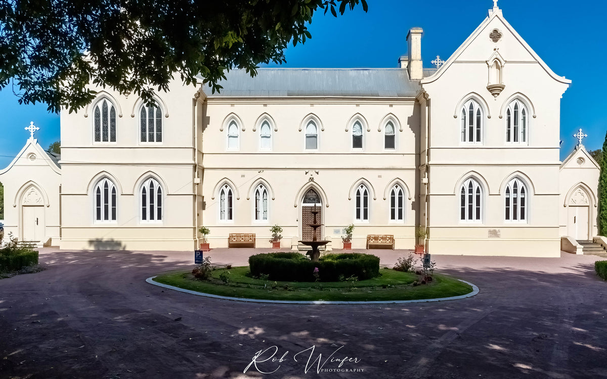 Rob Winfer photo of The front of the Convent at Koroit during the day with bright blue sky looking towards straight on.