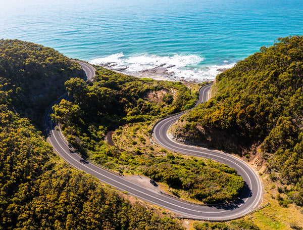 Twisting road with ocean next to it along the great ocean road.